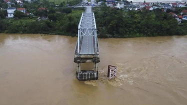 Bridge collapses as more rain falls in Vietnam and storm deaths rise to 21