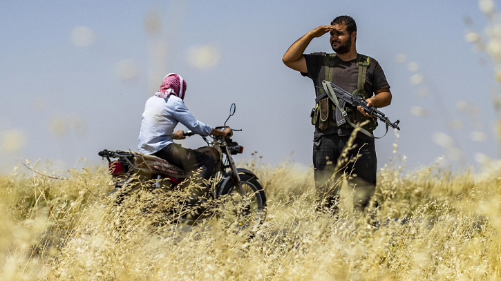 Armed Syrian Kurdish women stand guard over precious wheatfields